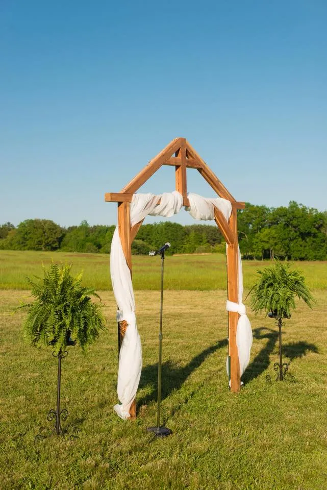 Wedding arbor with green field in background